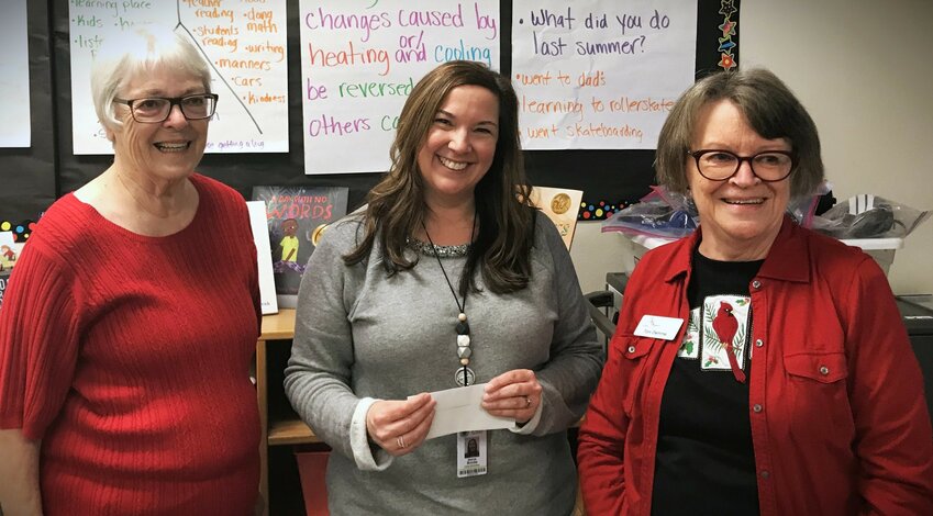 Altrusa members Lois Simko (left) and Toni Demme (right) present classroom grants to Lacey Elementary School teachers. The recipient pictured is 2nd grade teacher Melinda Brooks. December 14, 2023.