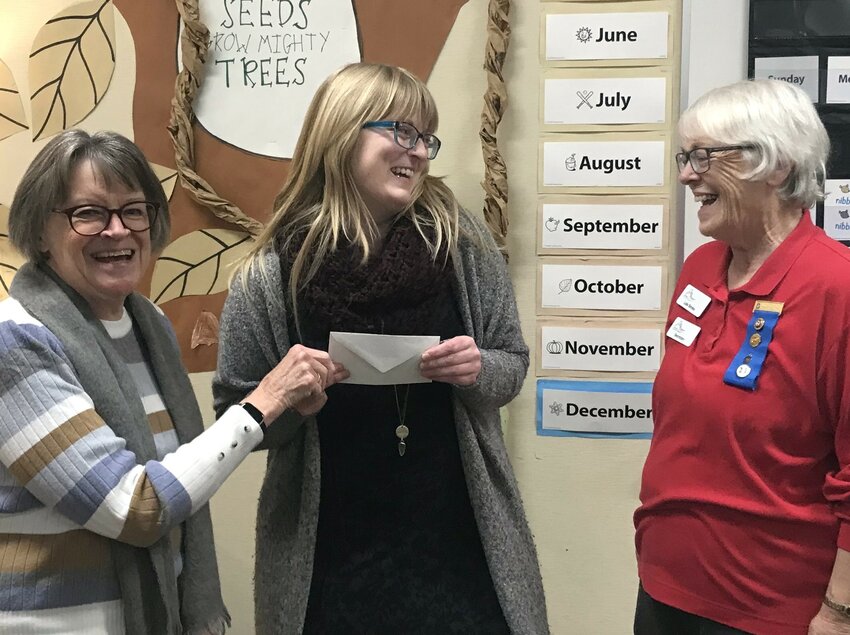 Altrusa members Toni Demme (left) and Lois Simko (right) present a classroom grant to Amanda Ryle, a first-year teacher at Garfield Elementary School in Olympia, WA, who teaches a split of first and second-grade classes, 2023.