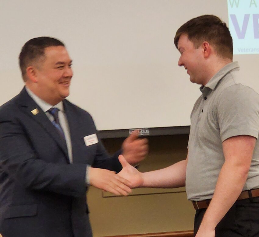 Damien Thomas (U.S. Army), the 1,000th student to complete the programs, received a certificate in Server and Cloud Application from Director Adam Takata. Dec. 15, 2023.