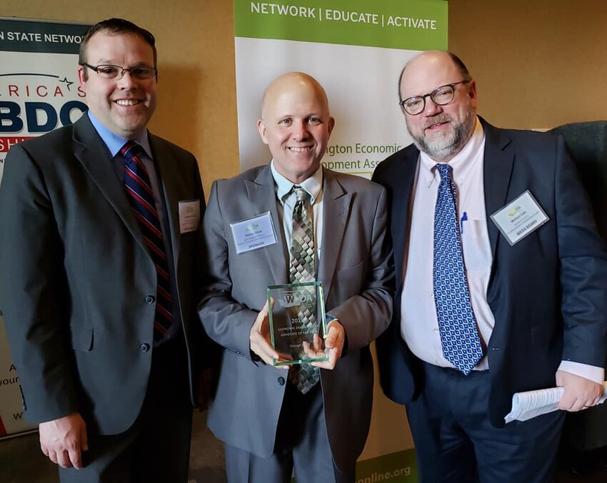 George Sharp (center) was named Economic Development Advocate of the Year Washington Economic Development Association, 2019. Shown on the right side of this photo is Michael Cade, executive director of the Thurston Economic Development Council.