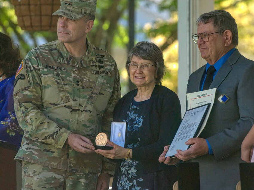 Katherine Bomersback-Baranowski receives her father’s Congressional Gold Medal from Maj. Gen. Matthew McFarlane, Deputy Commanding General, I Corps, Joint Base Lewis-McChord, on May 2, 2024.