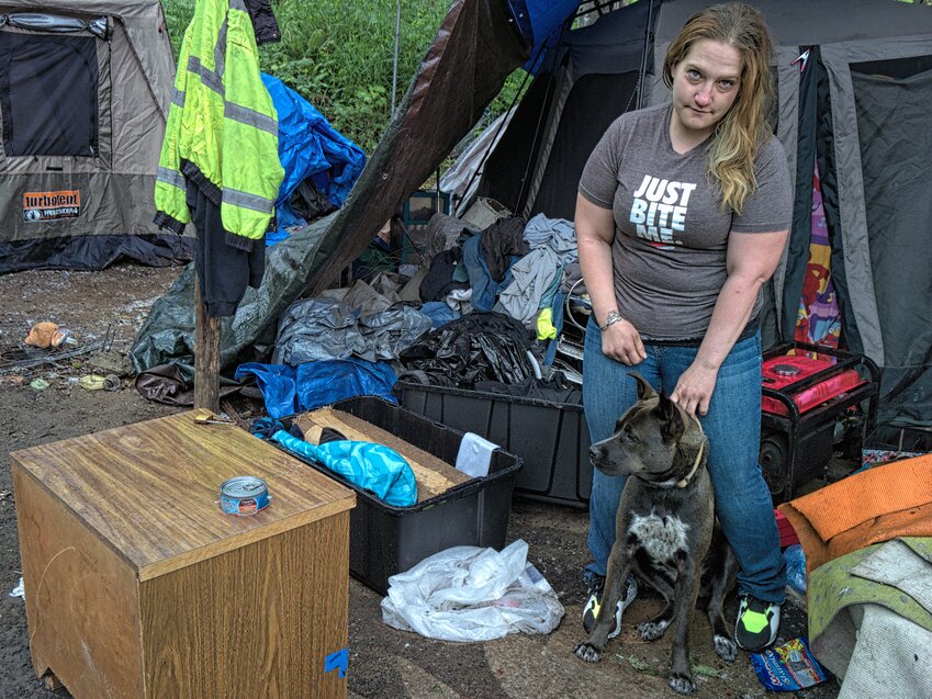 This woman, who granted permission for this photograph, contends that the water cannon on the fire truck knocked down her and her tent and destroyed some of her belongings.