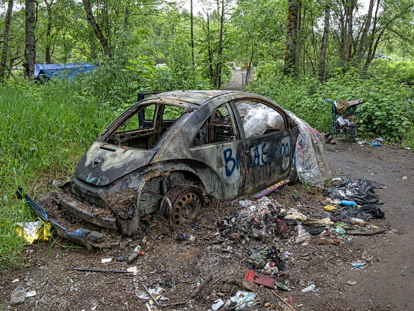 This is the car that burned on April 24. In the background is the blue tent of the woman who said the water cannon knocked down her tent and destroyed some of her belongings. Photo taken on May 24, 2024