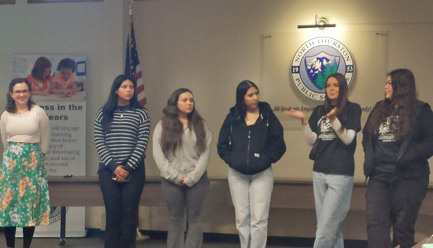 Students from River Ridge High School's Native Studies Program, with their teacher Alison McCartan (left), recount their experiences and learning opportunities in a presentation at the NTPS and Nisqually Tribal Council joint meeting.