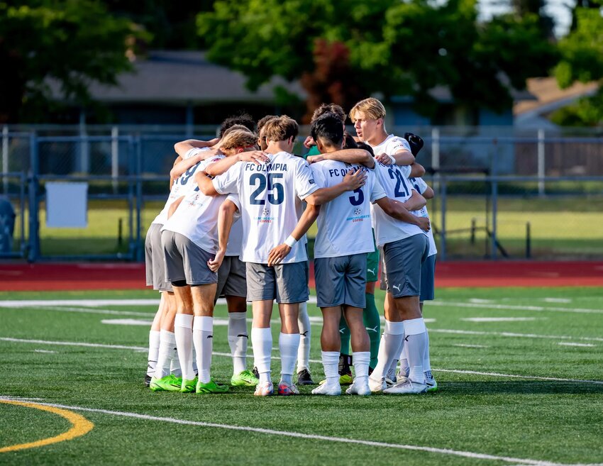 FC Olympia XI huddling before kickoff.