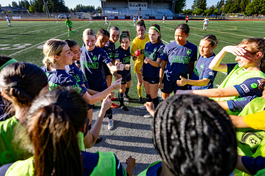 FC Olympia huddles to talk about strategy before their huge win vs United PDX FC.