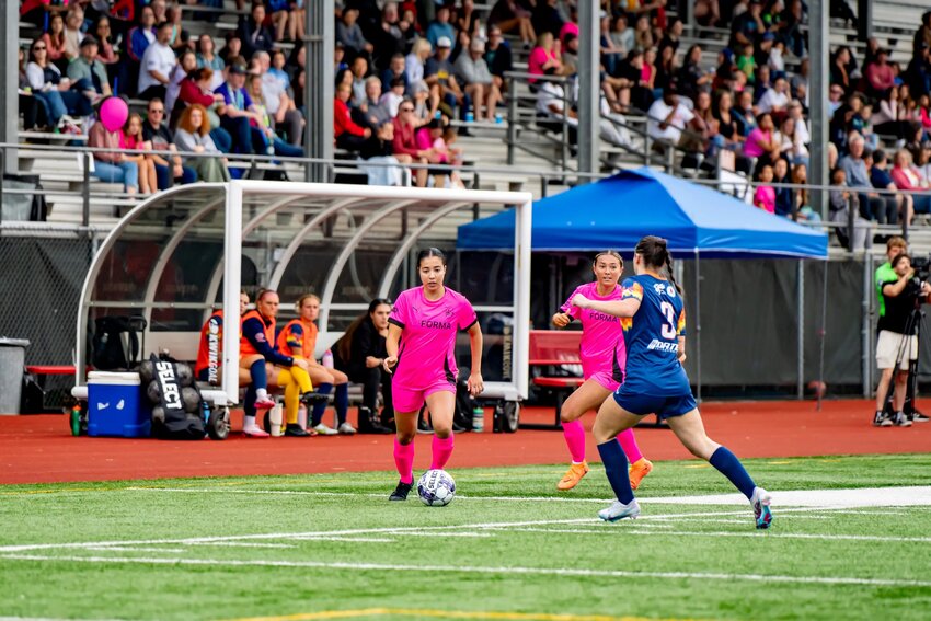 FC Olympia’s Maia Tabion (with the ball) performs in front of the biggest crowd in South Sound Stadium by far. She later scored a worldie.