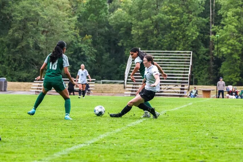 Evergreen State’s Cayla Muenchow crunches a slide tackle in their preseason match vs Saint Martin’s University