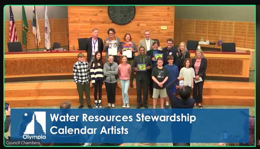 The Olympia councilmembers pose with middle school students whose artworks are featured in the 2025   Water Resources Stewardship through Art Calendar.