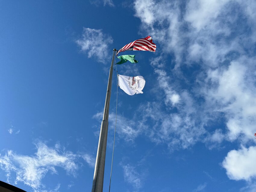 The Squaxin Island Tribe's flag flies below the Washington State and United States flags for the first time on October 21, 2024.