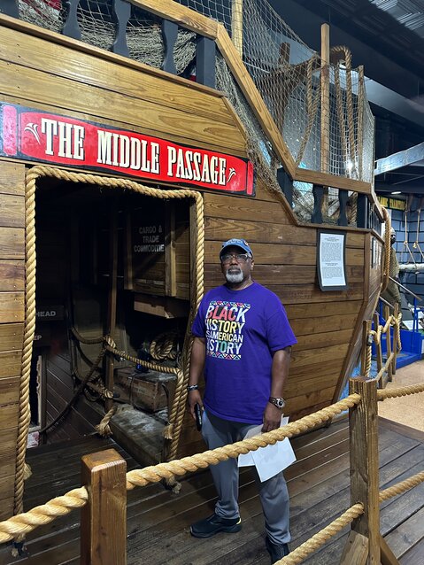 Jarvis stands on a slave ship replica at The National Great Blacks in Wax Museum.