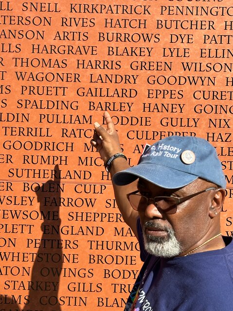 Jarvis Harris points to the name Harris on the monument wall at one of the Equal Justice Initiative (EJI) Legacy Sites.