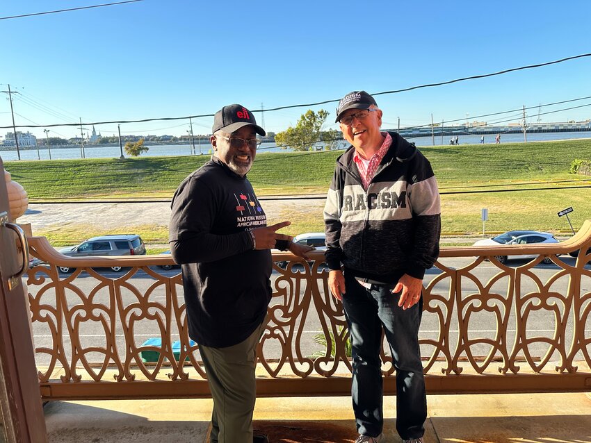 Jarvis and Joe on the balcony of the Algiers Courthouse in New Orleans, looking across the Mississippi toward the city's French Quarter.