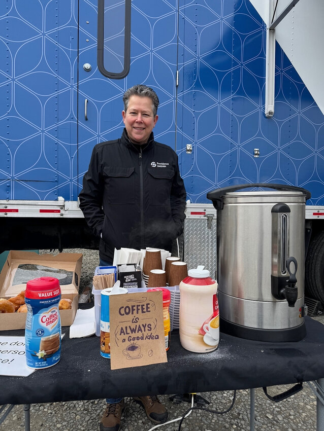 Tracy B. stands ready to serve coffee.