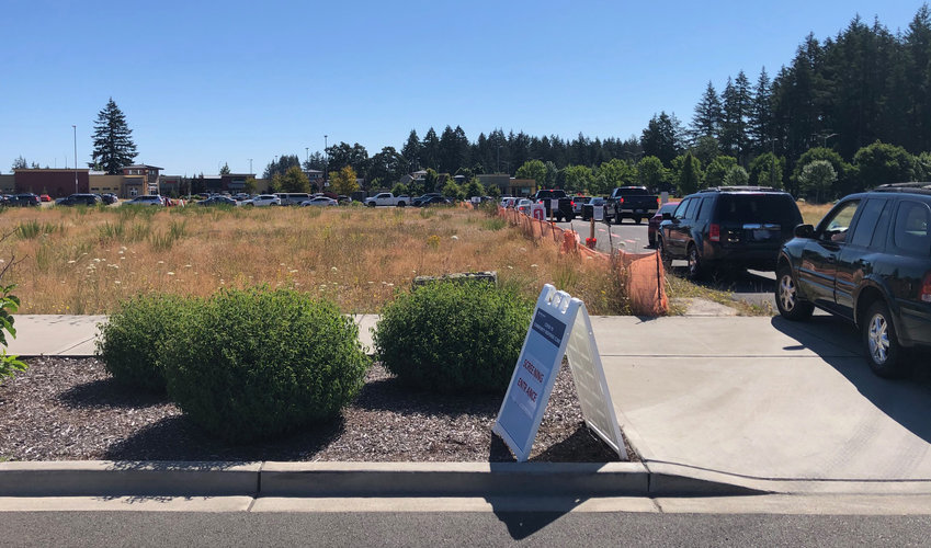 Providence Medical Group drive-through COVID-19 Testing:  In this image, from July 2020, some 30 cars reach from the driveway entrance to the cotton swab.