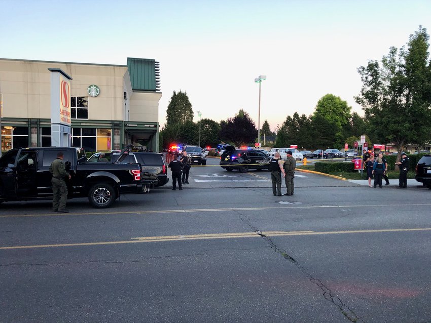 Several police agencies coordinated to clear all customers and Safeway employees out of the store as the suspect was armed and threatening to shoot.  Thurston County Sheriff SWAT vehicle is at the east side of the building in the center of this image.
