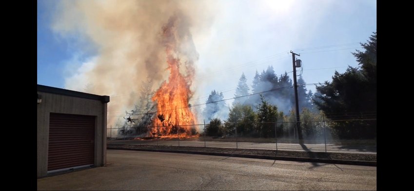 Firefighters from the Tumwater Fire Department responded to a fire by a storage facility off of Interstate 5 late Tuesday. The fire was caused by a boat that fell off a trailer, which caused dry grass and trees on the side of the road to start burning. Officials from other fire departments also responded to the incident.