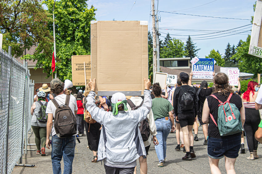Protestors marched through a West Olympia neighborhood on Sunday to protest chemical dispersion methods against crowds during demonstrations. The neighborhood was said to be the neighborhood some Olympia City Council members live in.