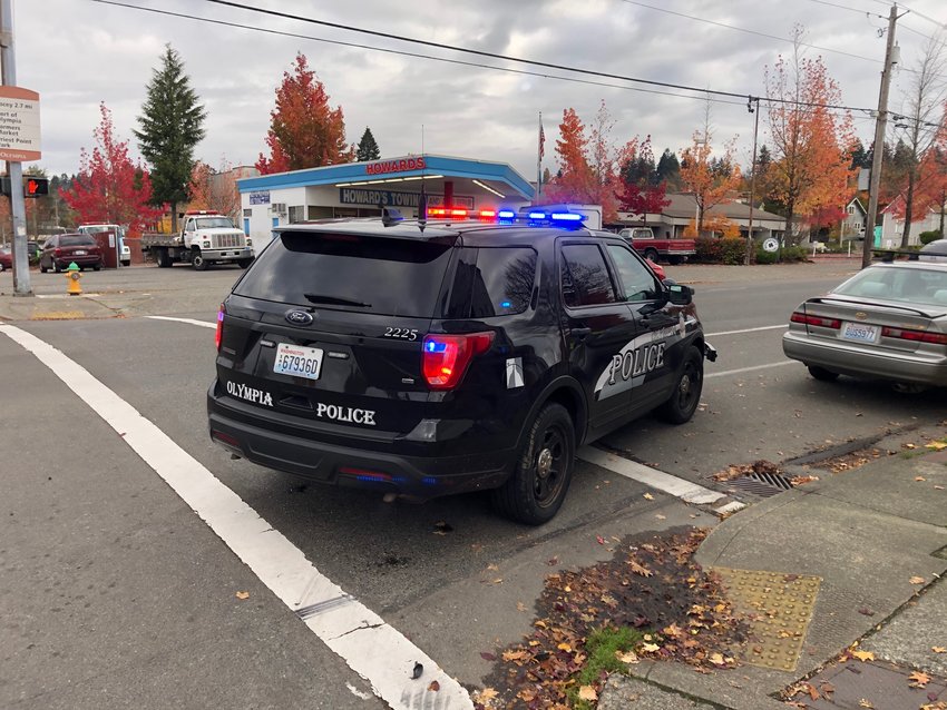An Olympia Police SUV is parked recently on Fourth Ave. E, near the scene of yesterday's arrest.