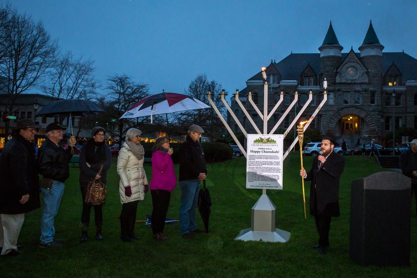 Lighting of Chabad of Olympia's 9-foot-tall menorah at Sylvester Park in downtown Olympia on Sun., Dec. 22, 2019. In attendance, l-r: US Rep. Denny Heck, Tenino City Councilmember John O'Callahan, Olympia City Council Member Renata Rollins, Olympia Mayor Cheryl Selby, State Rep. Beth Doglio, Thurston County Commissioner John Hutchings, Rabbi Yosef Schtroks.