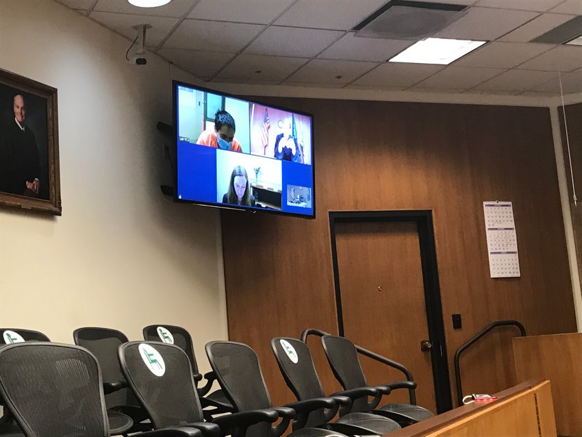 Jamie Montalvo Martinez, top left, appears in custody to Thurston County Superior Court via Zoom on Wednesday, Dec. 16, 2020. Montalvo Martinez is charged with first-degree murder and first-degree arson.