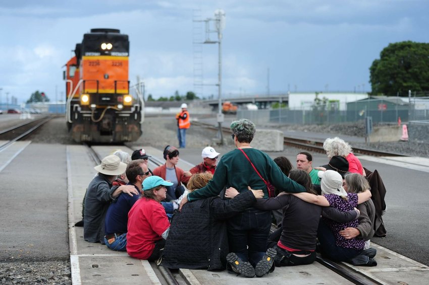 Cascadian activists have in some cases employed civil disobedience tactics in their fight to keep the region from becoming a major export center for planet-warming fossil fuels. Here, protesters block the main BNSF rail line in Vancouver, Washington, on June 18, 2016, as police begin to move in. The action was organized by the Fossil Fuel Resistance Network in response to a recent oil train derailment in Mosier, Oregon, to highlight the risks of fossil fuel transportation.