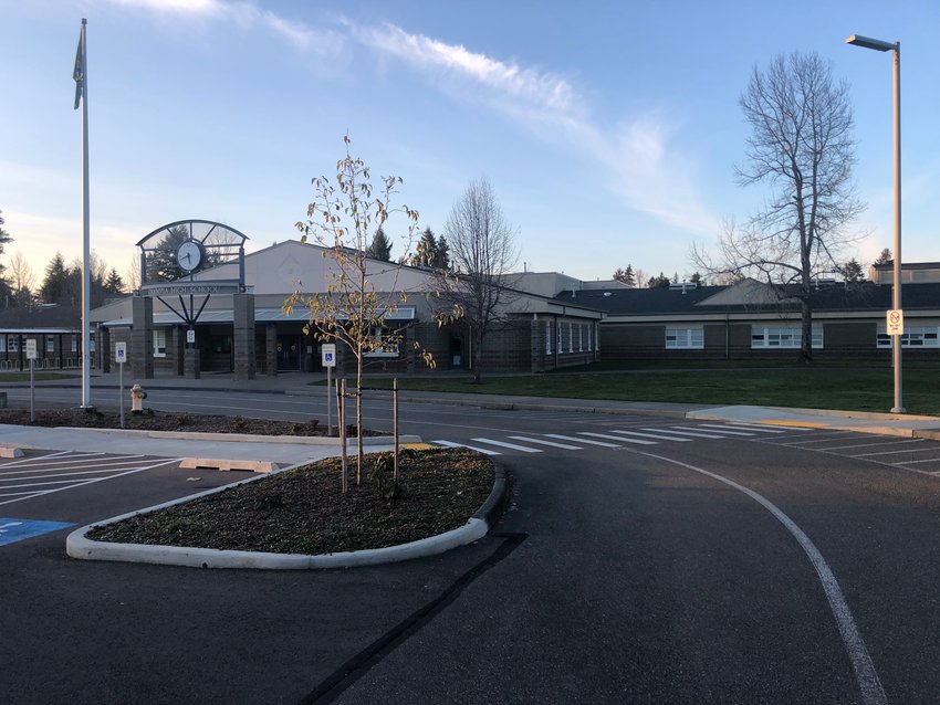 An array of solar panels is set to be installed on sections of Olympia High School's roof during the summer of 2021. A corner of the gymnasium is visible just to the right of the tree in the center of this image.