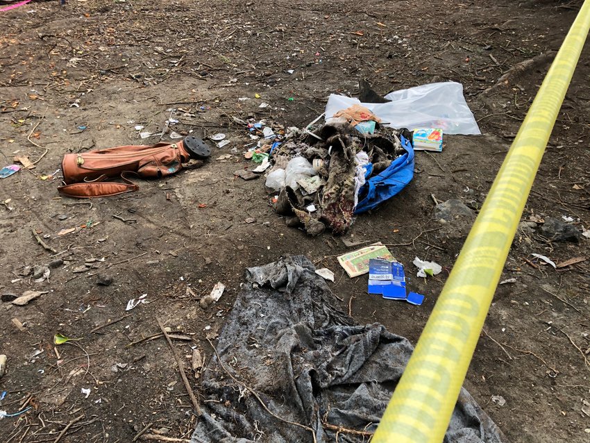 The debris spread around the grounds at the homeless encampment on Deschutes Parkway in Olympia was a mix of abandoned personal effects and trash, such as food package wrappers, stuffing such as is contained in sleeping bags, toys and outdoor clothing and discarded tents.