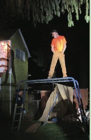 Corylee Bartlett on April 12, 2021 standing on a play structure prior to his arrest. He is speaking with a police officer who is standing below the structure.