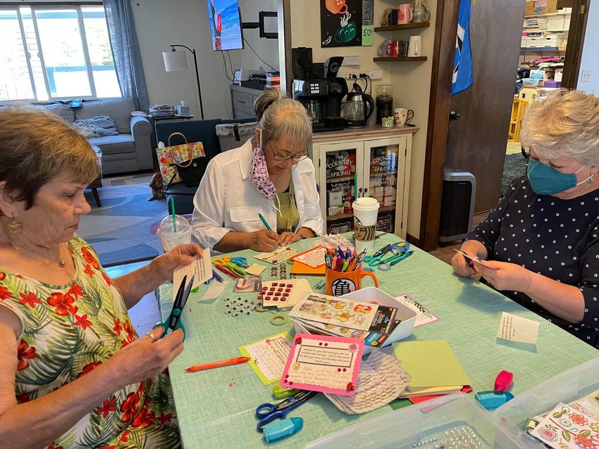 The ladies from the General Federation of Woman&rsquo;s Clubs&rsquo; Capital Woman's Club volunteered to help the Lacey~Oly Crafty Sewers to create inspirational messages which will go with each purse. Pictured, l-r: Dorothy Crowder, Nardine Sandberg and Karen Smith.