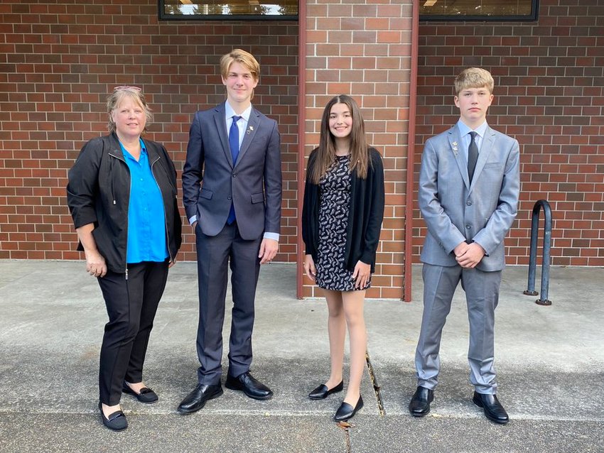 Komachin Middle School business education teacher Kate Reece poses with her students, Cyrus Biel, Issy Justis and Zeke Hanson, whose team ranked third at the national Future Business Leaders of America Fall Stock Market Challenge.