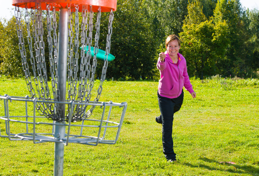 This woman is playing disc golf on one of the &quot;more than 9,800&quot; courses worldwide, according to The Professional Disc Golf Association.