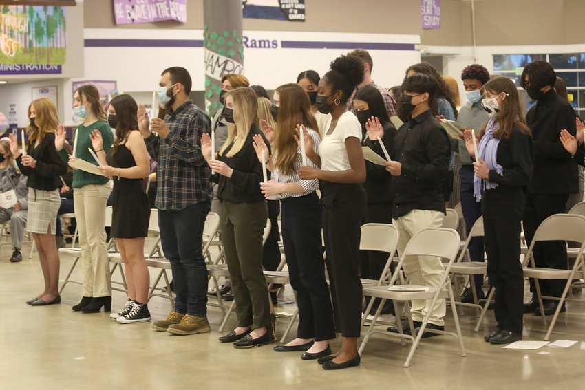 Student inductees recite their pledge.