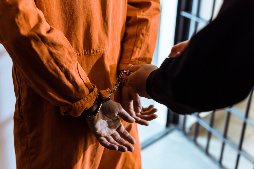 Orange jumpsuit, handcuffs, jail