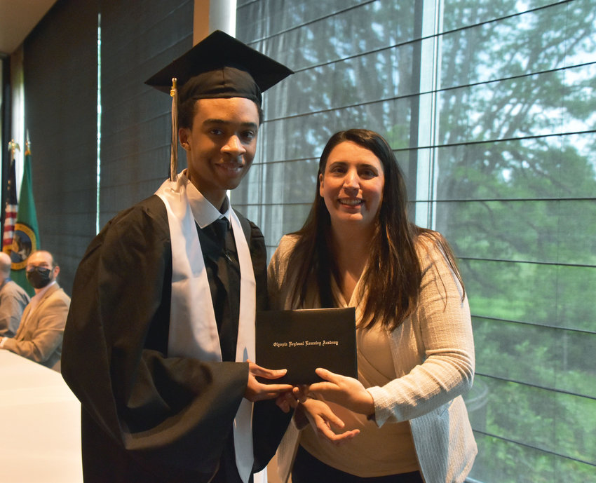 Olympia Regional Learning Academy student Jabron Amil Smith receives his diploma from Olympia School Board President Maria Flores.