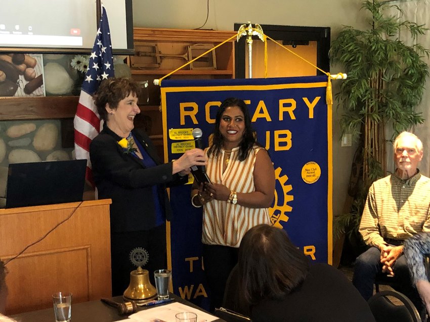 Denise Keegan, outgoing president of the Tumwater Rotary Club, presents Khurshida Begum, of A.S.H.H.O. Cultural Community Center, the 2022 Business Person of the Year award on June 29, 2022.