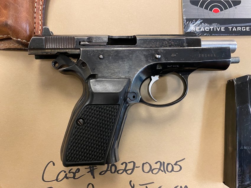 Police obtained a search warrant and found a black handgun behind the passenger seat.