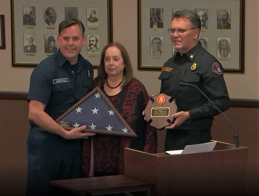Tumwater Fire Chief Brian Hurley and Mayor Debbie Sullivan awarded fire prevention officer Mark Armstrong (left)&nbsp;with a plaque recognizing him as 2022&rsquo;s Firefighter of the Year.
