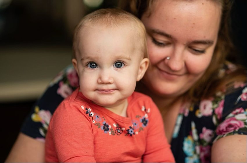 Baby Izzy looks into the future as she is held by her mother, columnist Alexis Rae Baker.