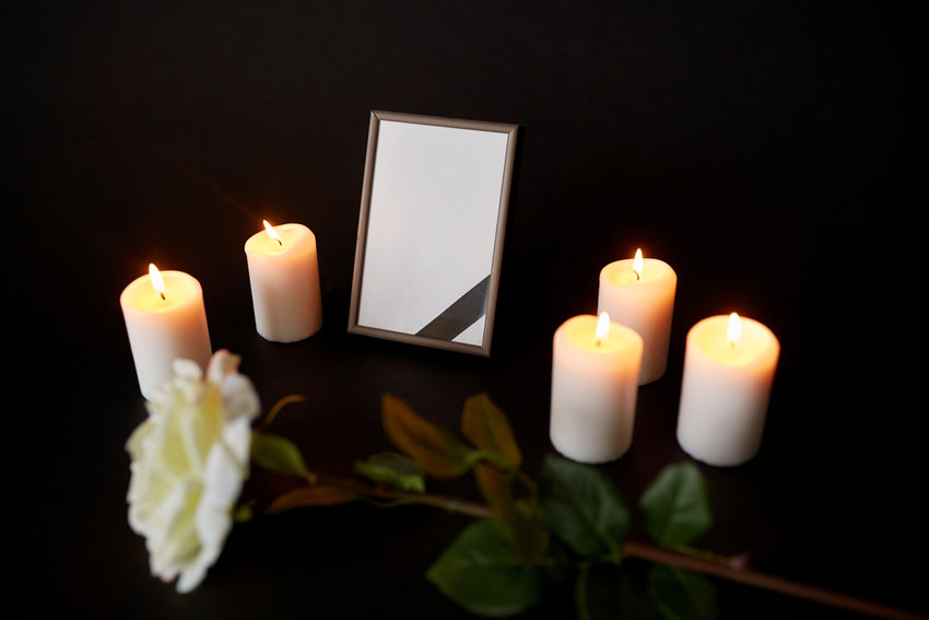 A family of five, including three children, died in a house fire in rural Thurston County early Saturday morning. Empty frame with a black ribbon, a white rose and five burning candles.