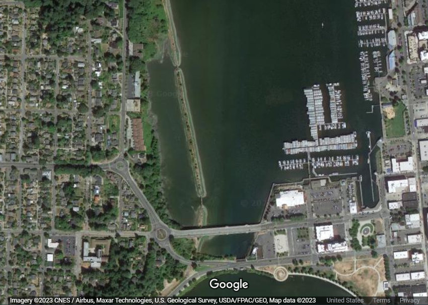 This image of downtown Olympia shows the Fifth Avenue Bridge, bottom center, and the railroad track berm across the water, slightly left of center. Some or all of this berm would be removed under various plans under discussion by Olympia officials in coordination with the Squaxin Island Tribe.
