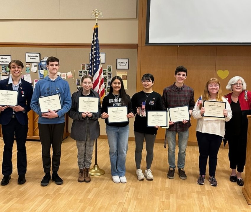 Students recognized for their biographies written for the Patriots of the American Revolution Essay Contest in Thurston County: Julien Bancroft-Connors, Chapman Anderson, Annalisa Born, Eliana Egrubay, Natsuki Kubota, Sawyer Anderson, Margaret 'Maggie' Watson, and DAR Regent, Mary Blake. (Patricia Egrubay is not pictured.)