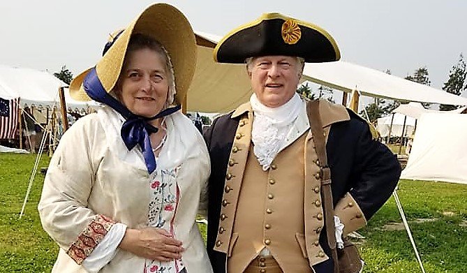 George Washington re-enactor Vern Frykholm Jr., poses with Bev York at the Northwest Colonial Festival, in front of the Washington Inn (a bed and breakfast), 2021.
