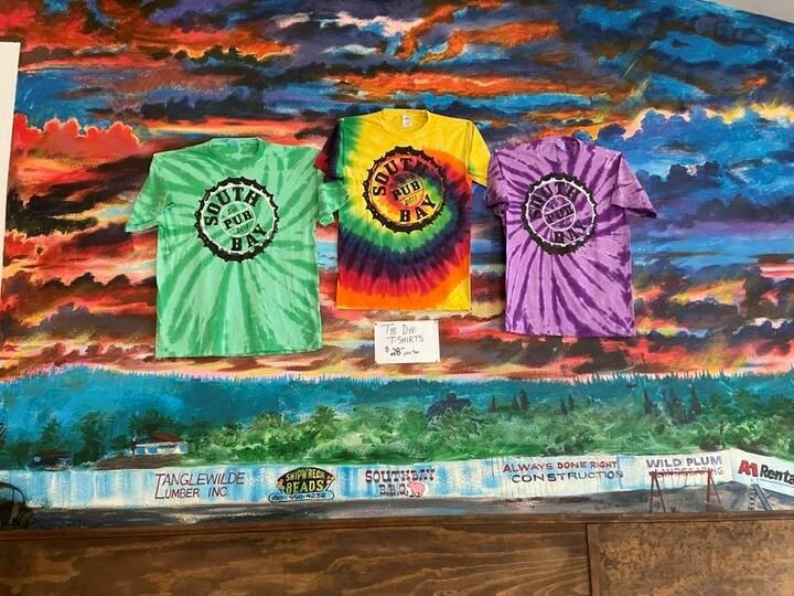 Tye dye shirts for sale in front of the mural at the Southbay Pub and Eatery.