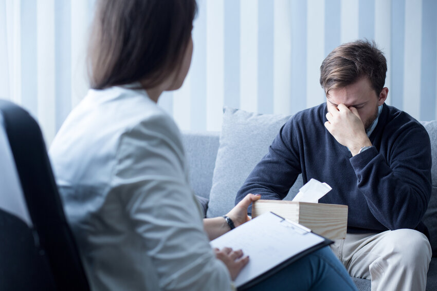 Photo of professional female counselor helping depressed man
