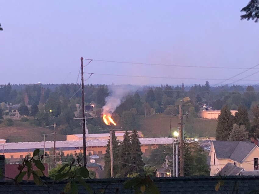 Two stripes of fire burned the hillside below Cleveland Avenue, across from the former Olympia Brewing Co. warehouse building, on July 4, 2023.
