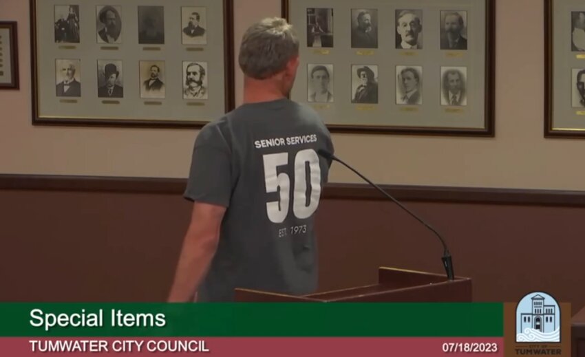 Senior Services for South Sound Executive Director Brian Windrope turns to show a 50th anniversary commemorative T-shirt for his organization.