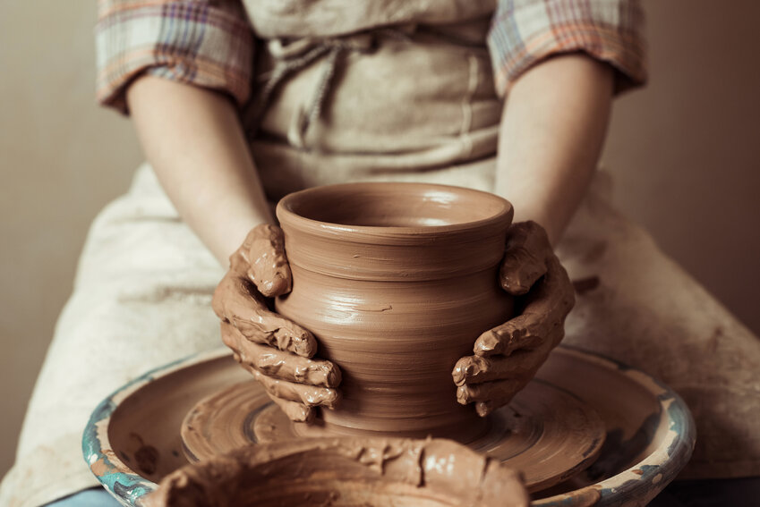Close up of hands working on pottery wheel at a workshop