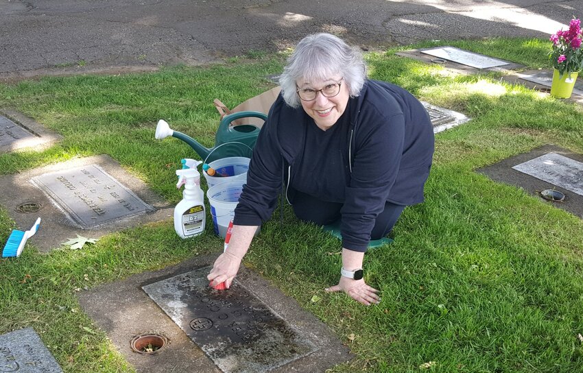 Franida Maudsley cleaning a veteran's grave at the Masonic Memorial Park in the very first month of the project.