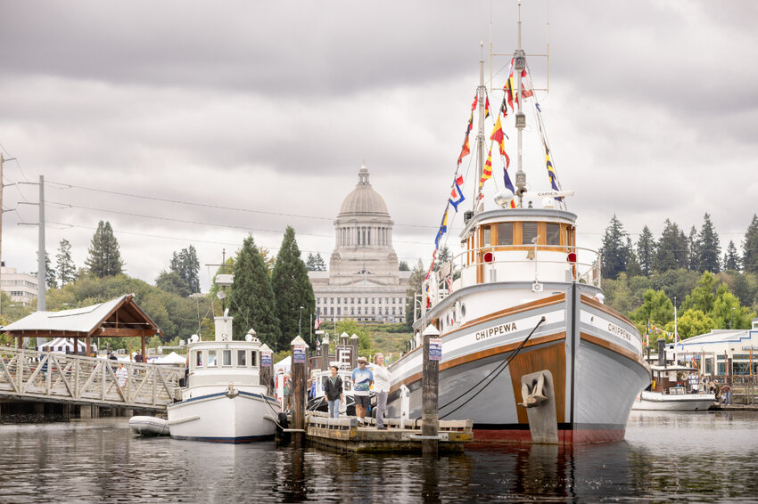 The tugboat Chippewa, shown on the right, is moored and receiving visitors during a previous Olympia Harbor Days festival.